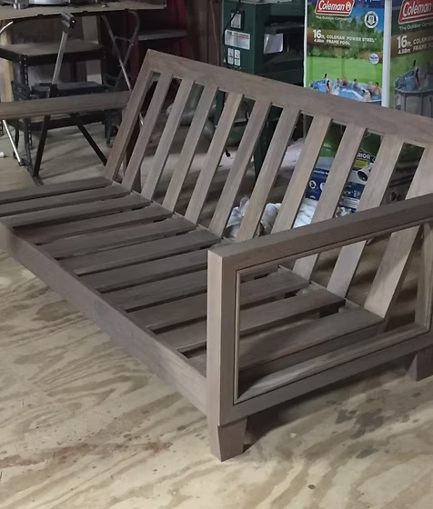 Hand-built hardwood futon frame in the Lagos workshop